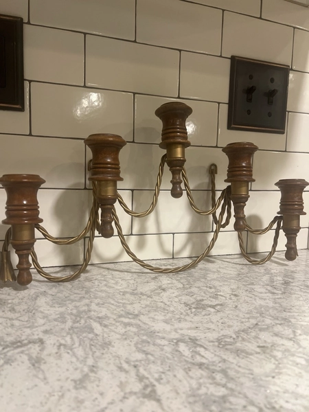 A vintage five-arm candelabra wall sconce with wood and twisted metal