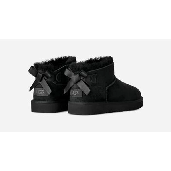 UGG® Women's Ultra Mini Bailey Bow Sheepskin Classic Boots in Black, Size 7