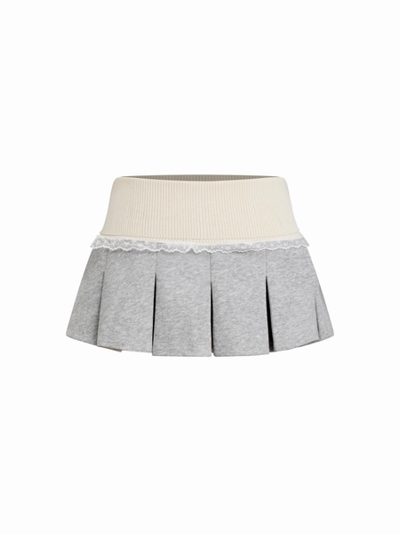 Jupe mini plissée bicolore en velours côtelé avec finition en dentelle
