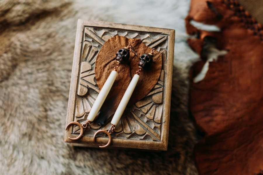 macabre moon. a pair of wooden skull earrings with long bone beads + copper moons.